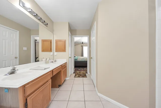 a spacious bathroom with a double vanity sink and a mirror