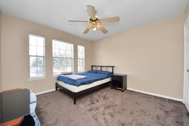 a bedroom with a bed and window