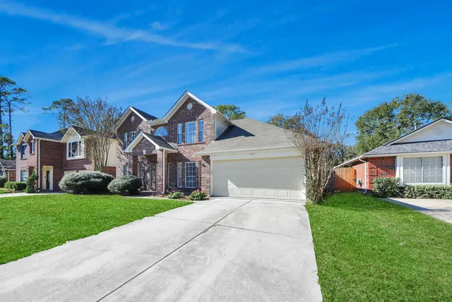 a front view of house with yard and green space
