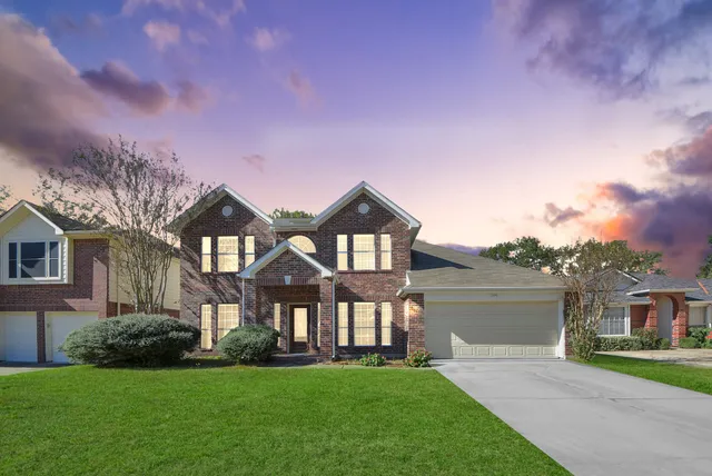 a front view of a house with a yard and garage