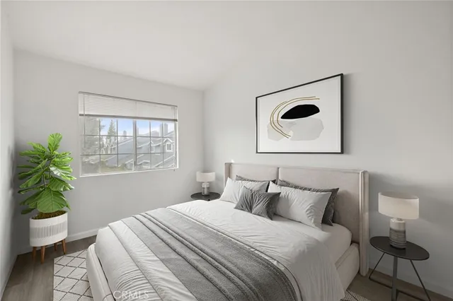 a bedroom with bed and a window