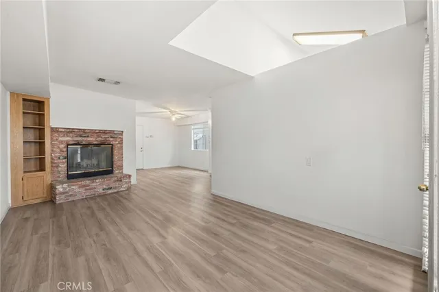 wooden floor fireplace and natural light in room