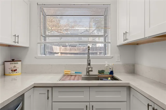 a kitchen with a sink and cabinets