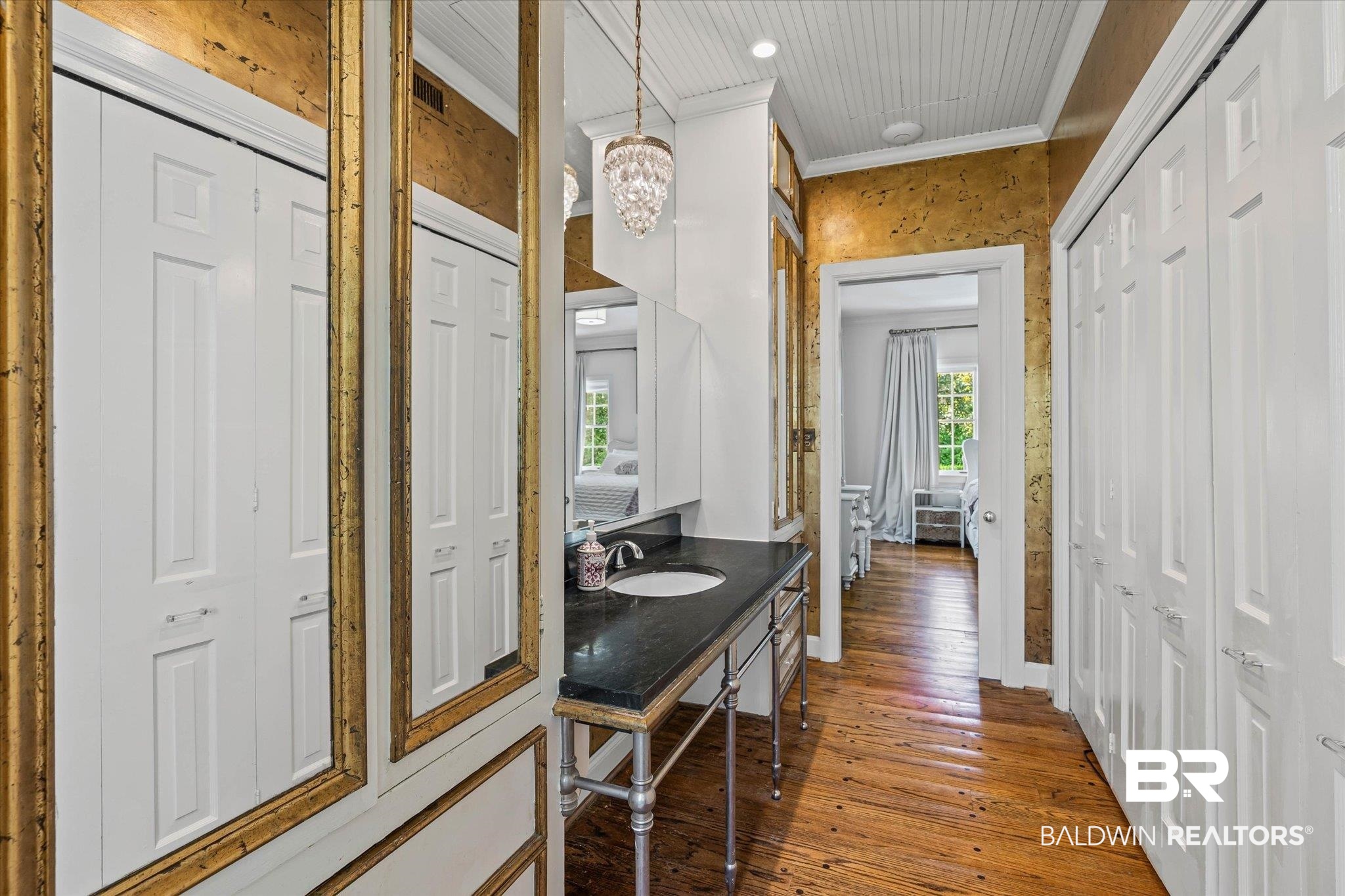 151 Tuthill Lane Mobile, AL 36608 - Photo 16 of 41 Bathroom featuring hardwood / wood-style floors, a chandelier, crown molding, vanity, and a closet