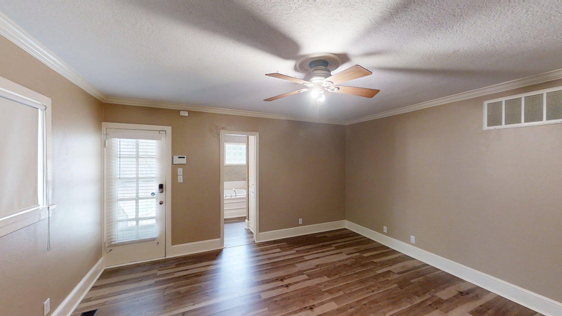 219 F Street Southwest Ardmore, OK 73401 - Photo 38 of 58 Wood-finish flooring, crown molding, and a ceiling fan with light fixture