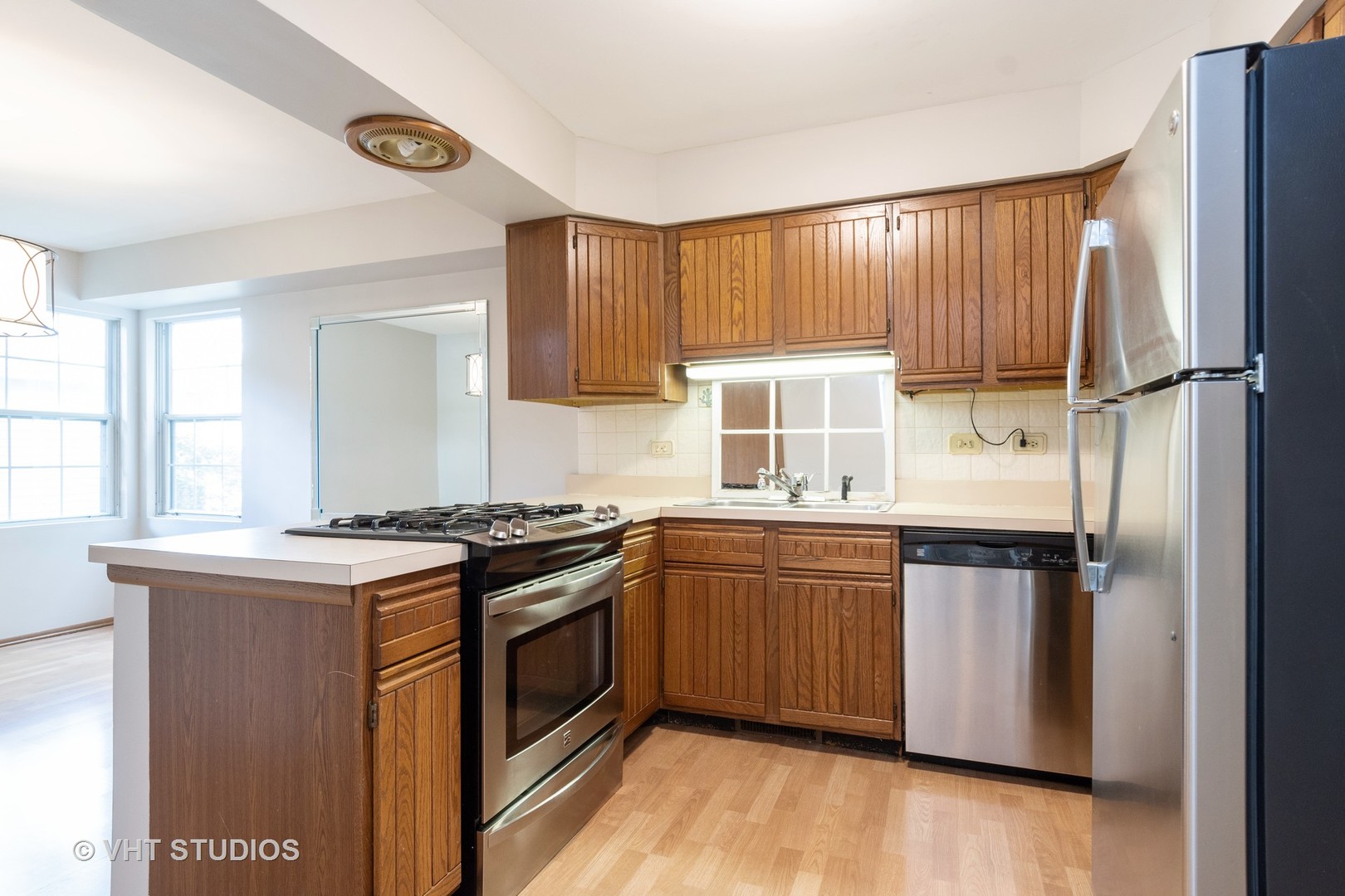1806 77th Street Naperville, IL 60565 - Photo 2 of 13 a kitchen with stainless steel appliances granite countertop a stove a sink dishwasher and a refrigerator