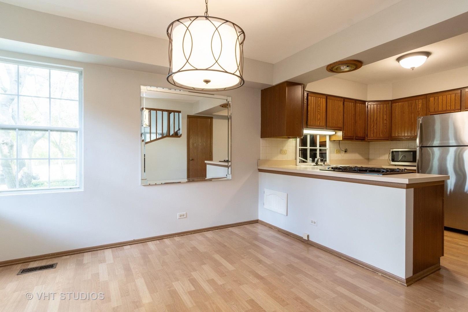 1806 77th Street Naperville, IL 60565 - Photo 3 of 13 a kitchen with stainless steel appliances granite countertop a refrigerator a stove and a sink with wooden floor