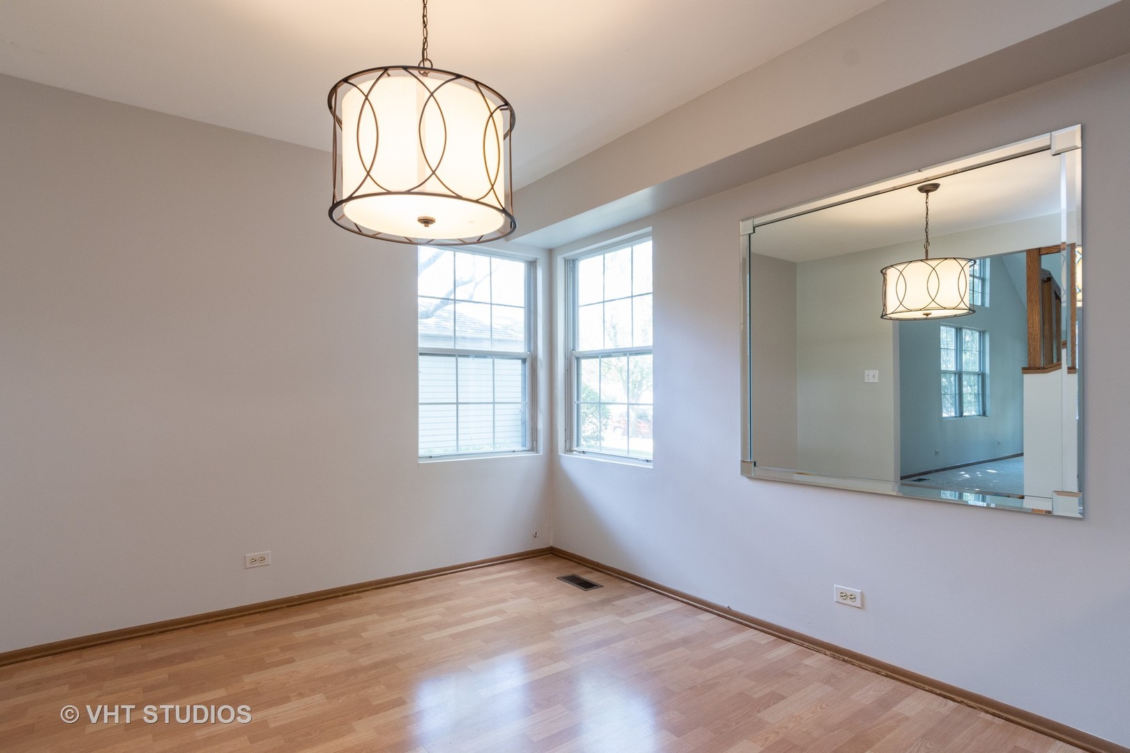 1806 77th Street Naperville, IL 60565 - Photo 4 of 13 an empty room with wooden floor and windows