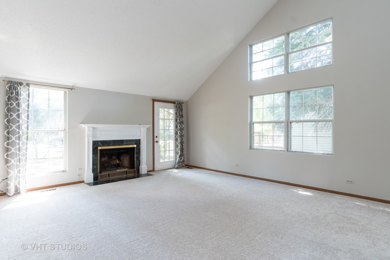1806 77th Street Naperville, IL 60565 - Photo 5 of 13 an empty room with windows fireplace and windows