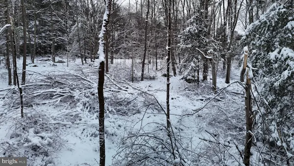 a view of a dirt road with a view of house