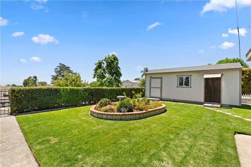 8527 Hillside Road Rancho Cucamonga, CA 91701 - Photo 31 of 50 a front view of a house with a garden and yard