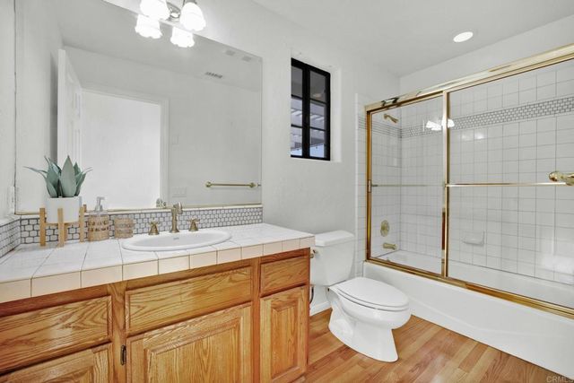 a room with wooden floor and white walls