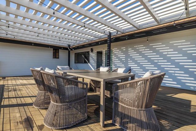 a view of a patio with table and chairs and potted plants