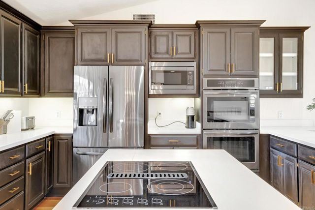 a living room with furniture and a large window with wooden floor