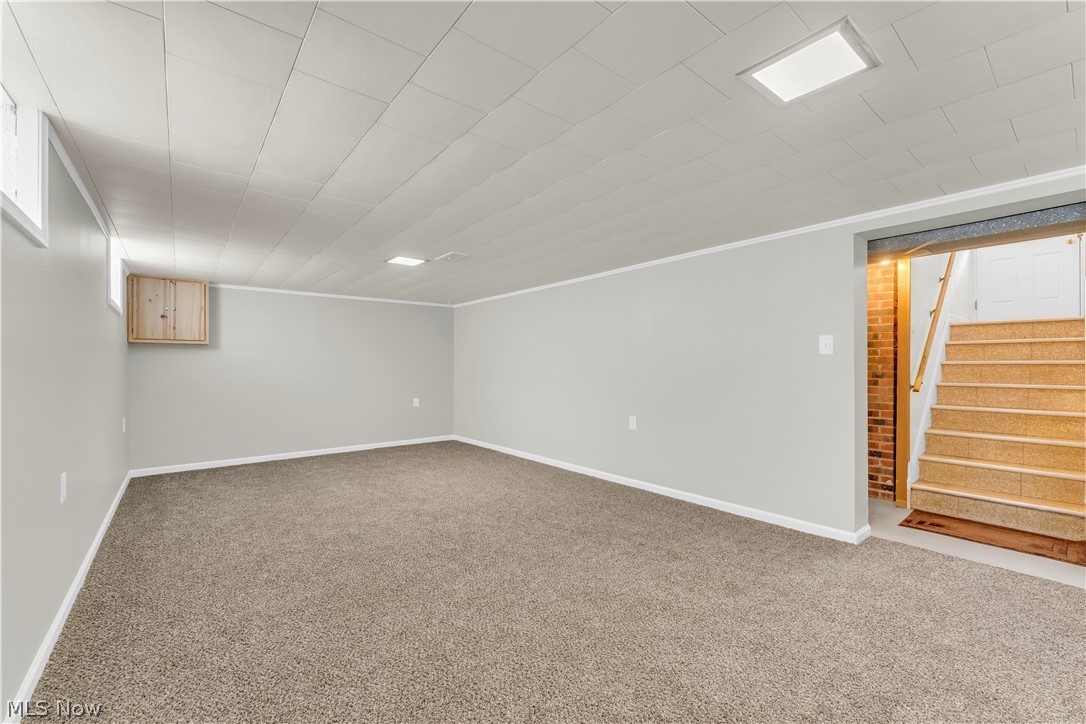3023 Norris Avenue Cleveland, OH 44134 - Photo 29 of 41 Spacious carpeted room featuring light gray walls, white trim, recessed lighting, and a paneled ceiling