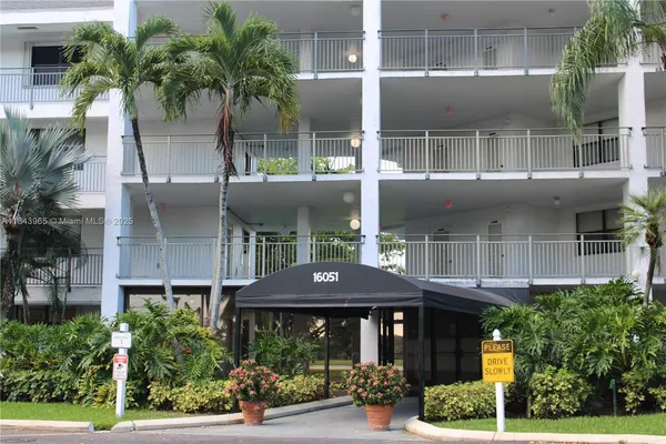 a front view of house with a garden