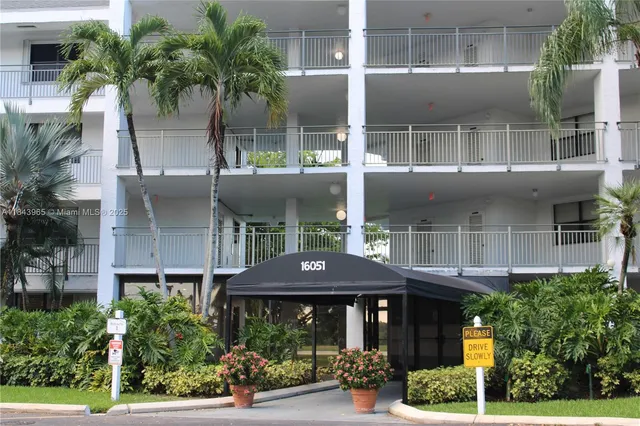 a front view of house with a garden