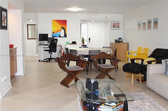 a living room with lots of furniture and painting on the wall