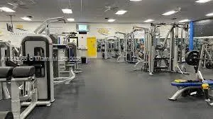 a room with gym equipment and a large window