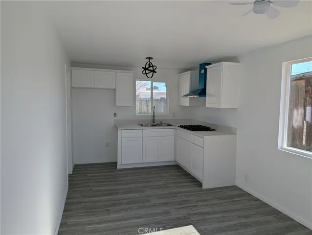 a kitchen with stainless steel appliances granite countertop a sink a stove and a granite counter tops