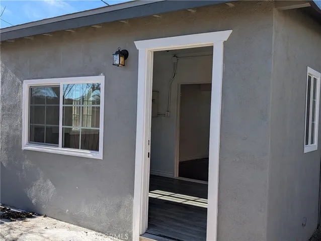 a kitchen with sink a window and cabinets