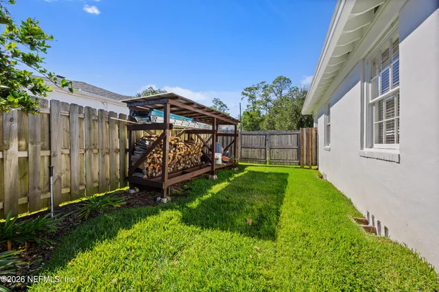 a view of backyard with a garden and deck
