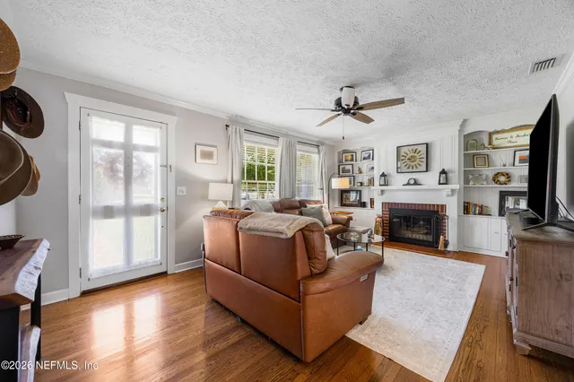 a living room with furniture a fireplace and a flat screen tv
