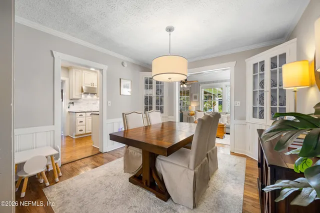 a dining room with furniture and a chandelier