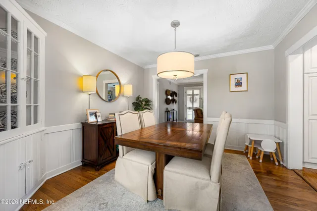a view of a dining room with furniture and chandelier