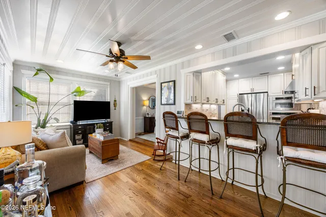 a living room with lots of furniture and a flat screen tv