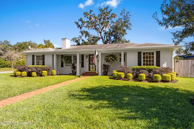 a view of a house with a yard patio and fire pit