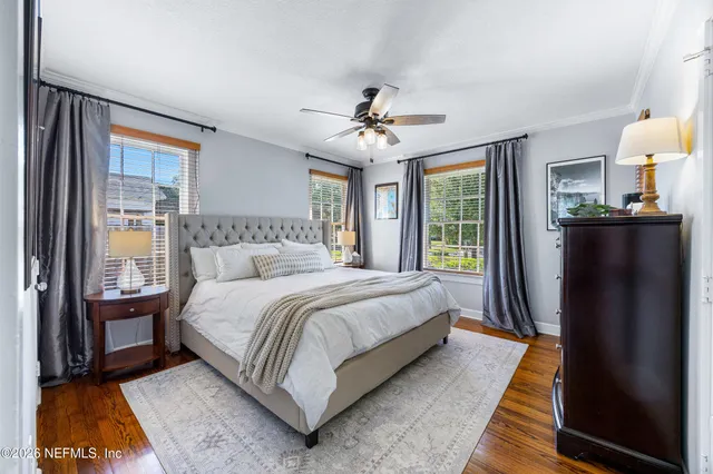 a spacious bedroom with a bed and glass door
