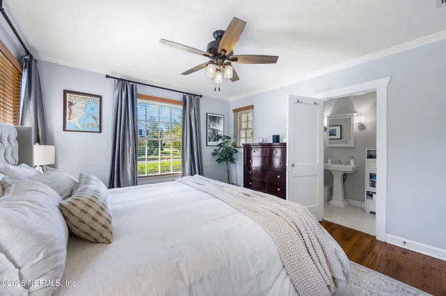 a bedroom with a bed and large window