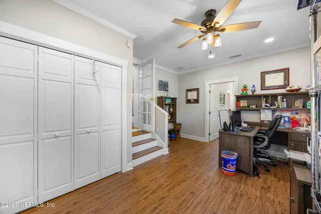 a view of a workspace with furniture and wooden floor
