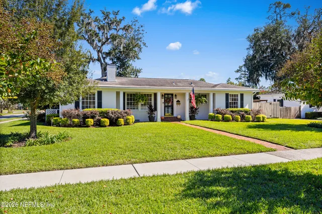 a front view of a house with a yard table and chairs