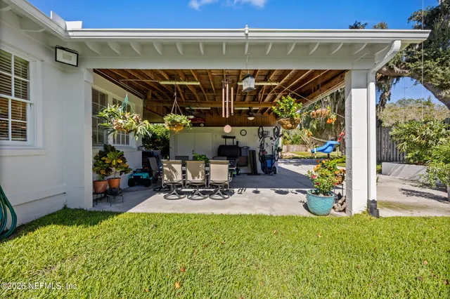 a view of a patio with a table and chairs