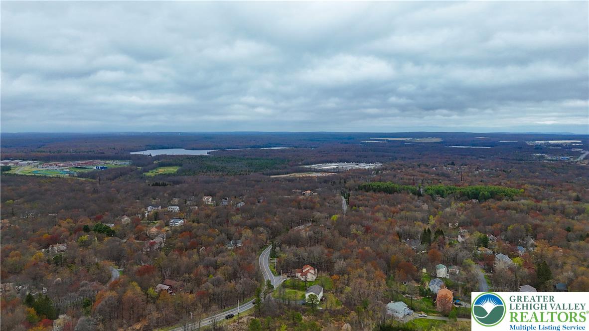 2742 Long Pond Road Long Pond, PA 18334 - Photo 6 of 57 An aerial perspective reveals a vast forested landscape with scattered residences and distant bodies of water.