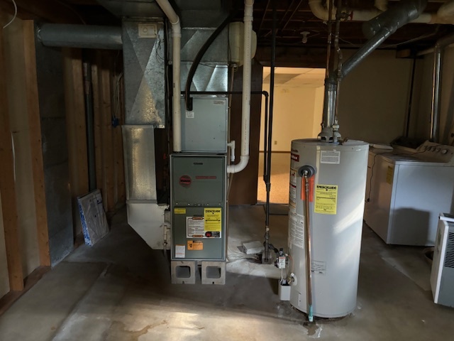 5287 South Mill Pond Road Rochelle, IL 61068 - Photo 40 of 50 a room with water heater and wooden cabinets