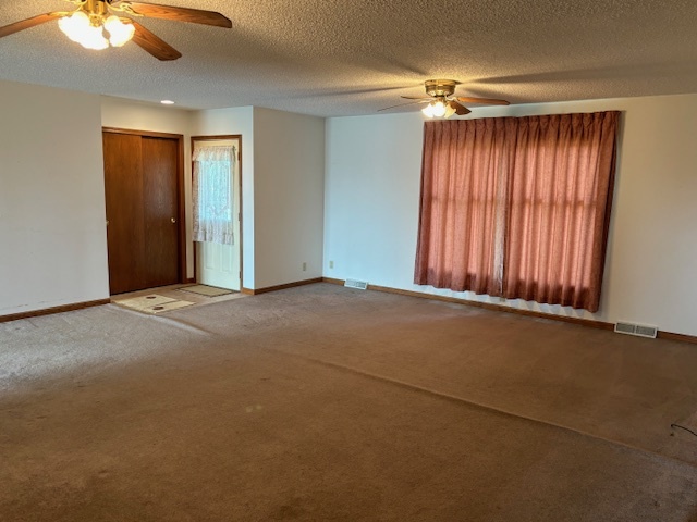 5287 South Mill Pond Road Rochelle, IL 61068 - Photo 6 of 50 a view of a room with a large window and a ceiling fan