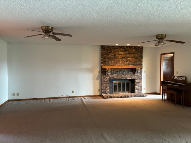 5287 South Mill Pond Road Rochelle, IL 61068 - Photo 9 of 50 a view of a livingroom with a fireplace and a chandelier