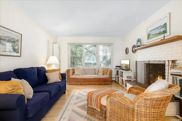 a living room with furniture fireplace and a large window