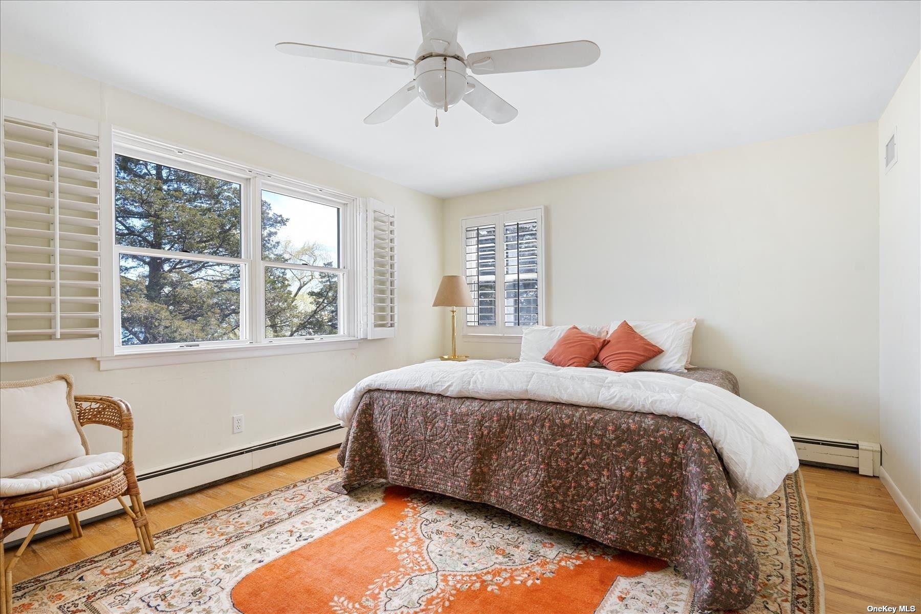 1155 Old Harbor Road New Suffolk, NY 11956 - Photo 15 of 21 a bedroom with a bed and a window