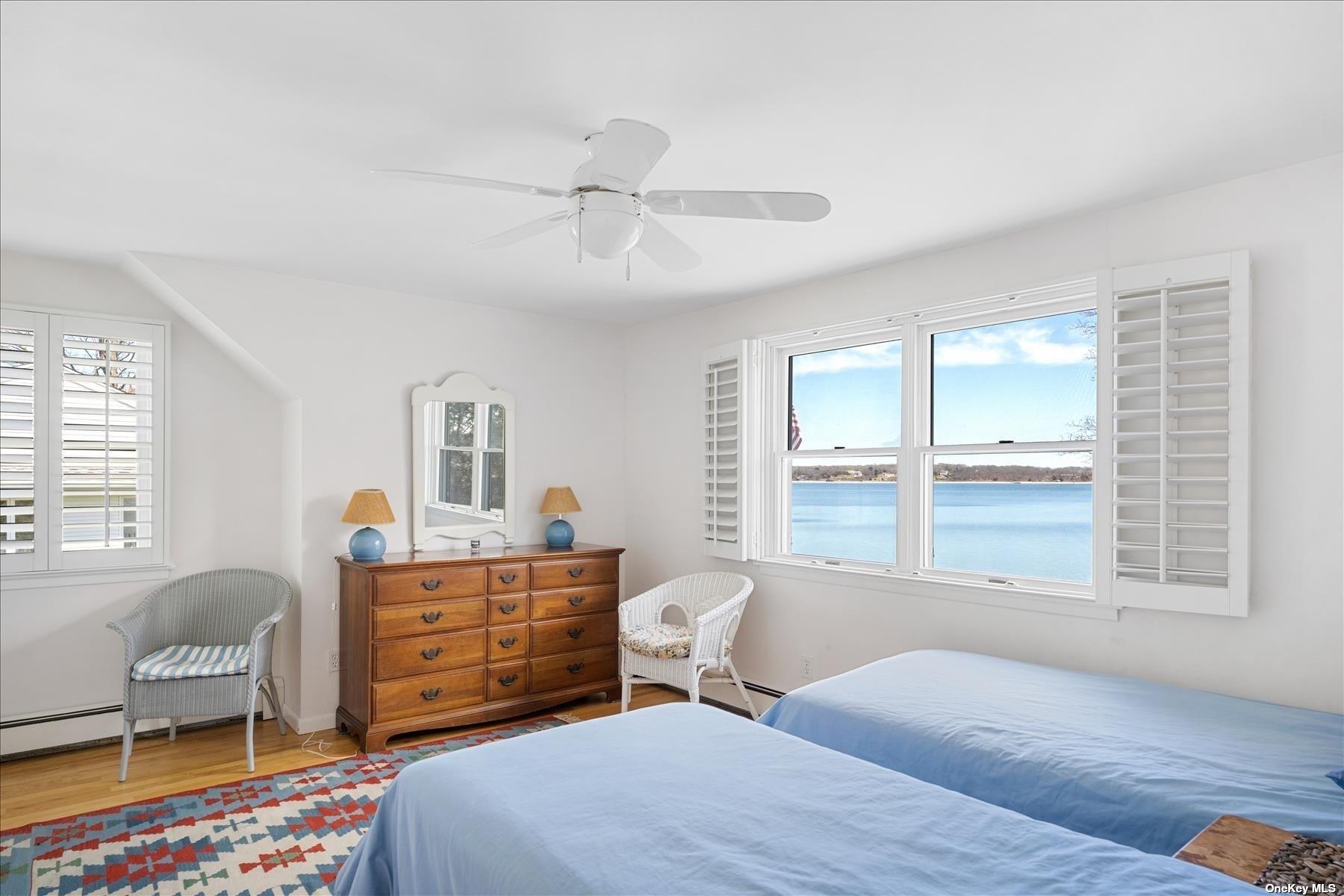 1155 Old Harbor Road New Suffolk, NY 11956 - Photo 16 of 21 a bedroom with a bed and wooden floor
