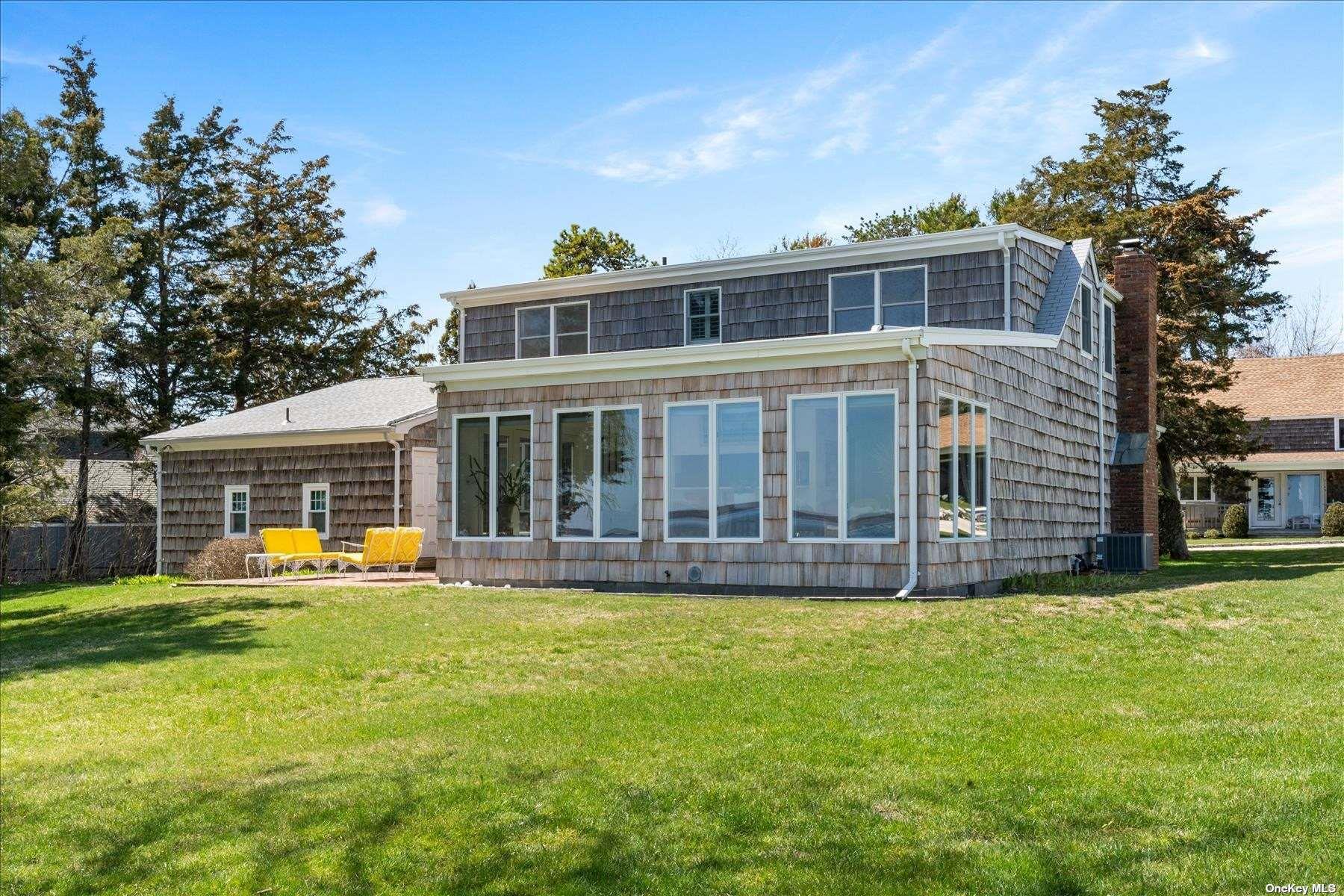1155 Old Harbor Road New Suffolk, NY 11956 - Photo 5 of 21 a front view of house with yard in front and trees