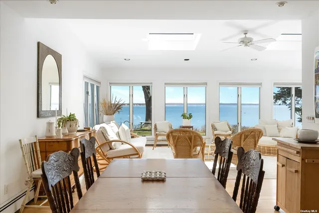 a living room with furniture fireplace and large windows