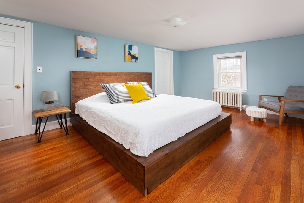 113 Payson Road Brookline, MA 02467 - Photo 11 of 16 a bedroom with a bed and a table in it