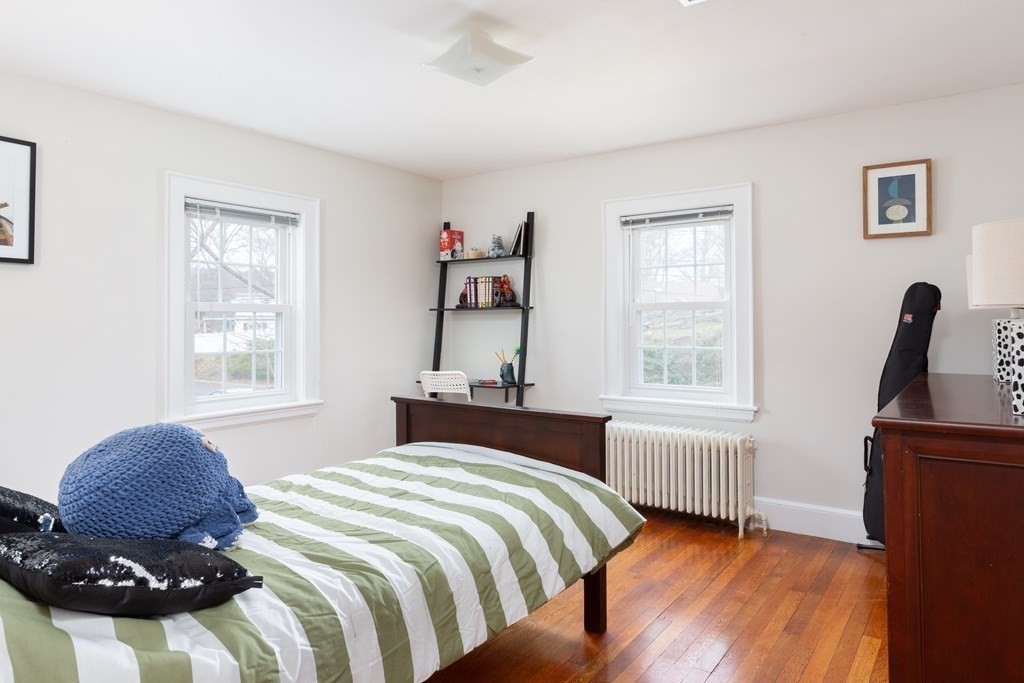 113 Payson Road Brookline, MA 02467 - Photo 12 of 16 a bedroom with a bed and wooden floor