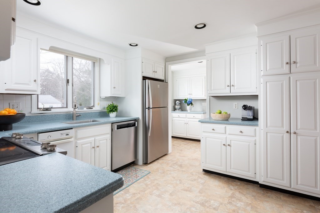 113 Payson Road Brookline, MA 02467 - Photo 8 of 16 a kitchen with white cabinets and white appliances