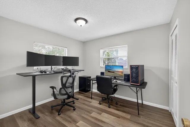 a view of a workspace with furniture and a window