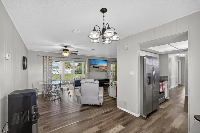 a view of a dining room with furniture wooden floor and chandelier